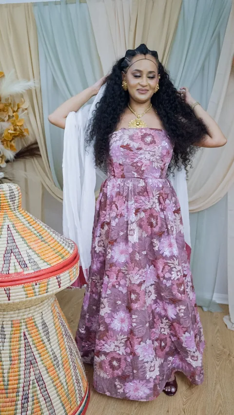 A portrait with both hands raised into the hair, the drape falling