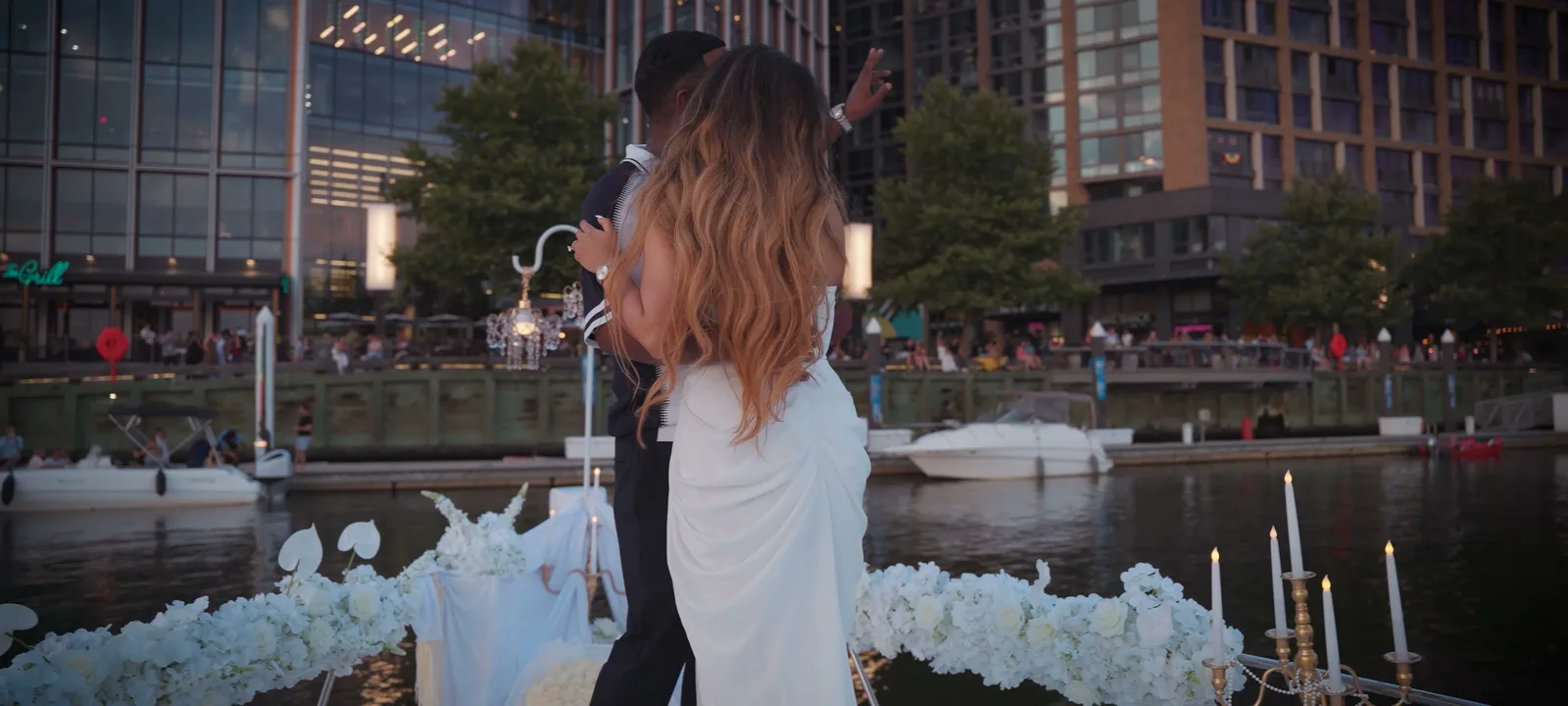 A couple embracing on the wharf at golden hour